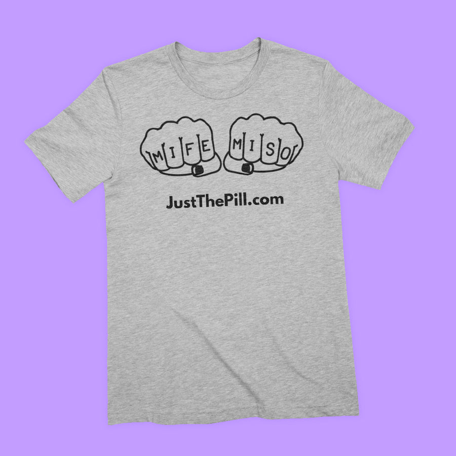 Heather grey tee featuring black print of a line illustration of fists, the knuckles of which read MIFE and MISO. Under the illustration is "JustThePill.com" in sans serif font.