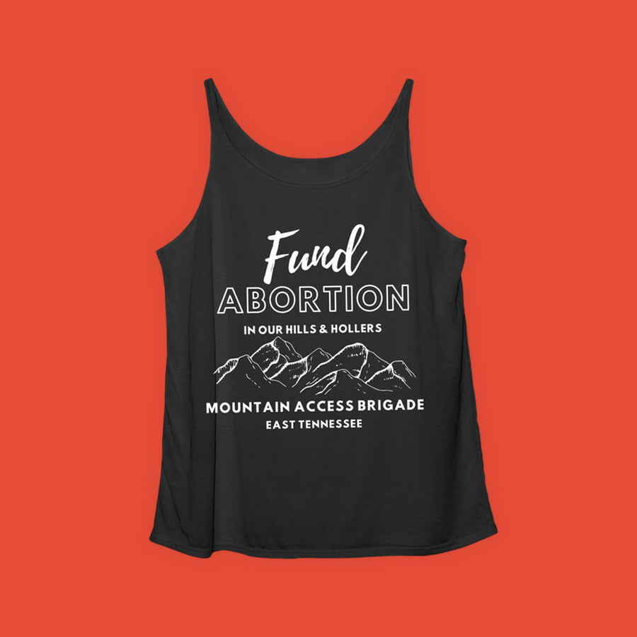 White text on a blank tank top reads "Fund abortion in our hills and hollers" above an illustration of a mountain range. Below, white text reads "Mountain Access Brigade; East Tennessee"