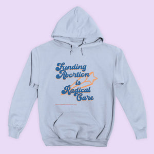 A sky blue pullover hoodie imprinted with a retro, "Reading Rainbow"-esque design that reads "Funding abortion is radical care" in royal blue letters and a gold shooting star.