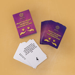 Photo of a deck of "Heart-To-Heart Abortion Conversation" cards, their box, and a few overturned cards, on a yellow background. The top card reads, "What does personal autonomy mean to you? Do you feel like you can make your own decisions about your path in life? Why or why not?"